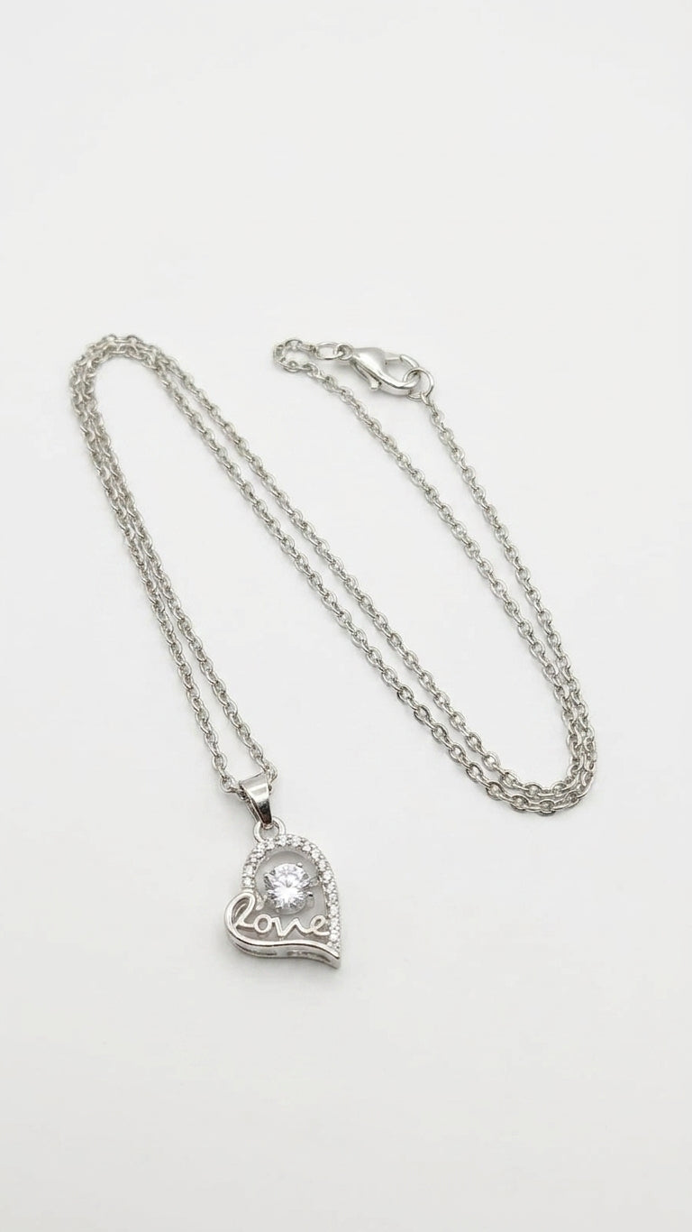 Silver CZ love heart necklace displayed in open wooden jewelry box with navy velvet lining – AureliaBlends