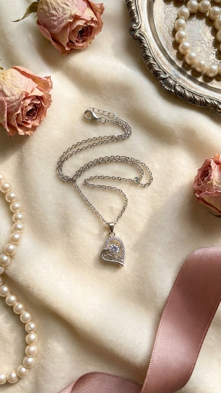 AureliaBlends silver CZ love heart necklace lifestyle flat lay with flowers and love letter