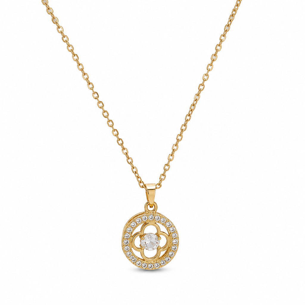 Woman wearing gold CZ clover medallion pendant necklace with cream V-neck silk blouse at collarbone – AureliaBlends Belle Fleur Collection lifestyle model shot