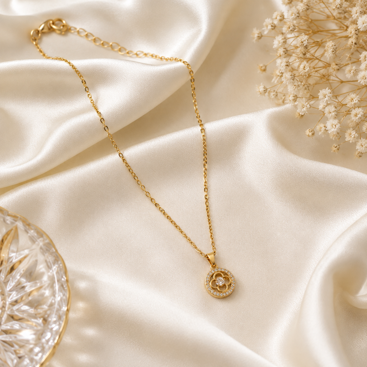 Gold CZ clover medallion pendant necklace on black marble surface in dark luxury interior with gold furniture – AureliaBlends UAE Dubai luxury jewelry editorial