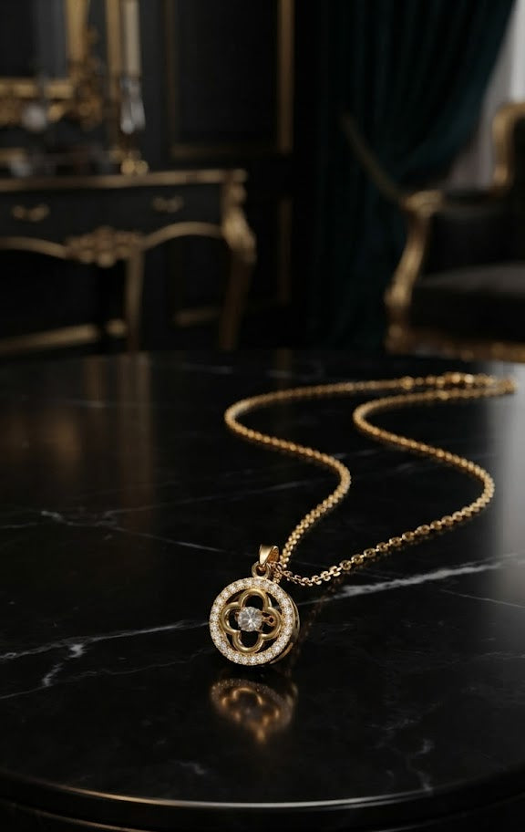 Gold CZ clover medallion pendant necklace on black velvet showing open four-petal clover motif with round-cut CZ centre stone and pavé CZ halo rim – AureliaBlends