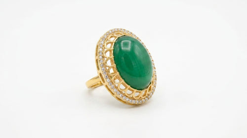 Emerald green oval stone gold statement ring in a luxury green velvet gift box with eucalyptus and candles – AureliaBlends bridal jewelry