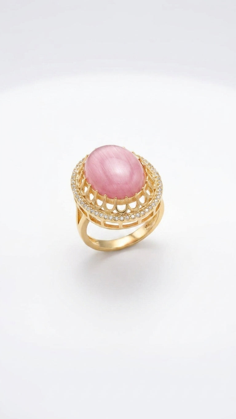 Pink oval cabochon stone gold-plated statement ring with cubic zirconia pavé halo on white background – AureliaBlends
