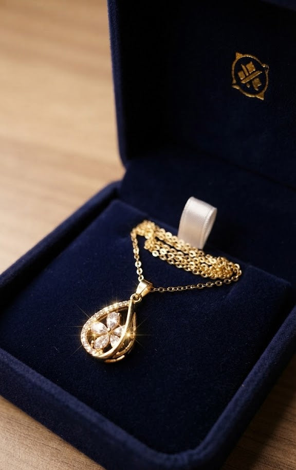 Close-up of gold CZ clover teardrop pendant necklace with sparkling cubic zirconia stones – AureliaBlends