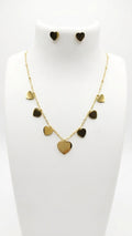 Gold heart charm necklace and stud earrings set on white jewelry bust display – AureliaBlends