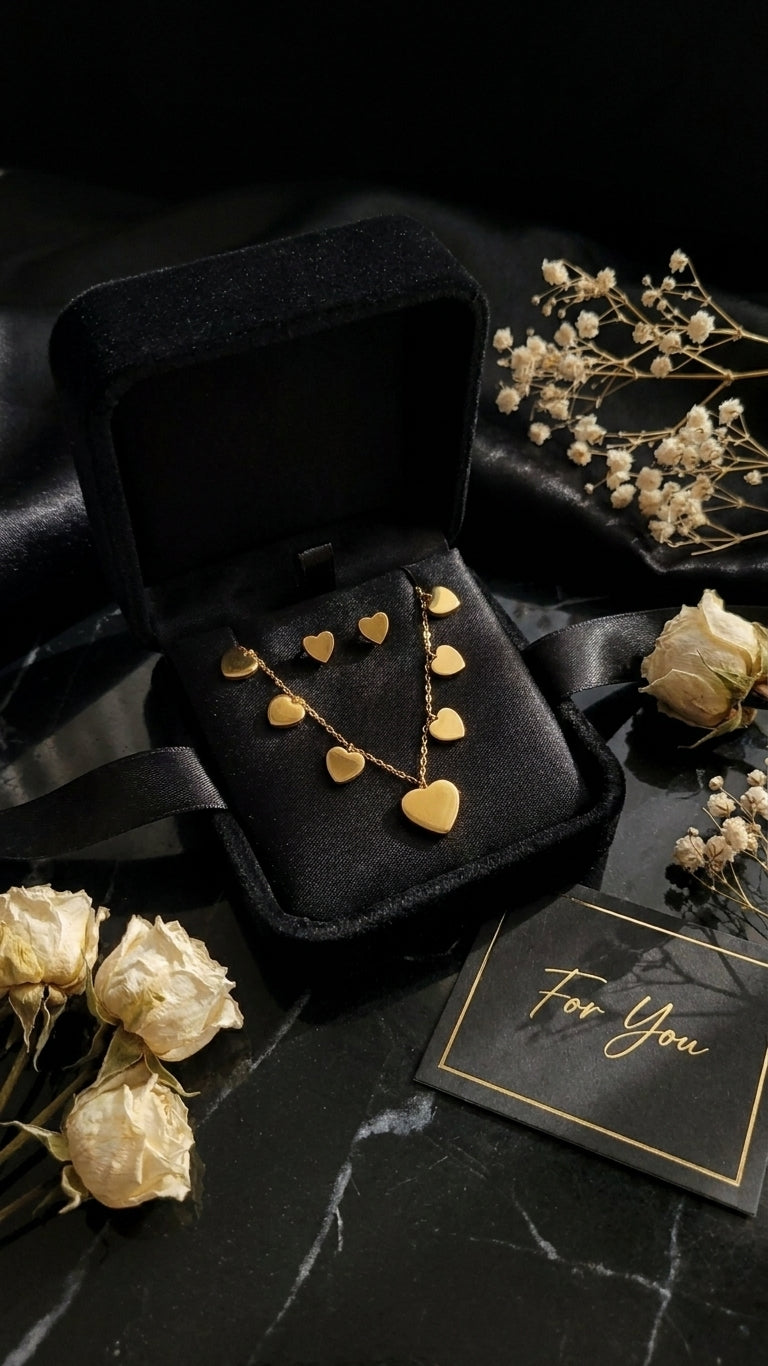 Gold heart charm necklace and earrings set in black velvet gift box with For You card surrounded by pink and white roses – AureliaBlends