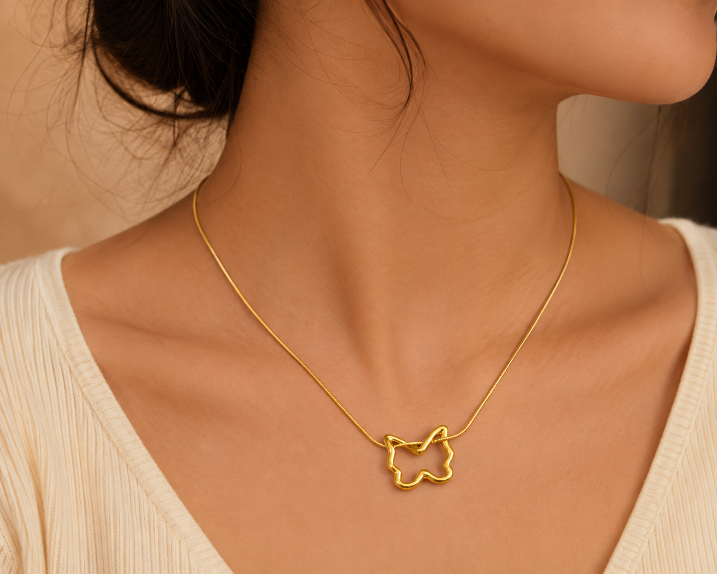 Gold butterfly pendant necklace on black satin with dried flowers – elegant gold-plated charm necklace for evening wear