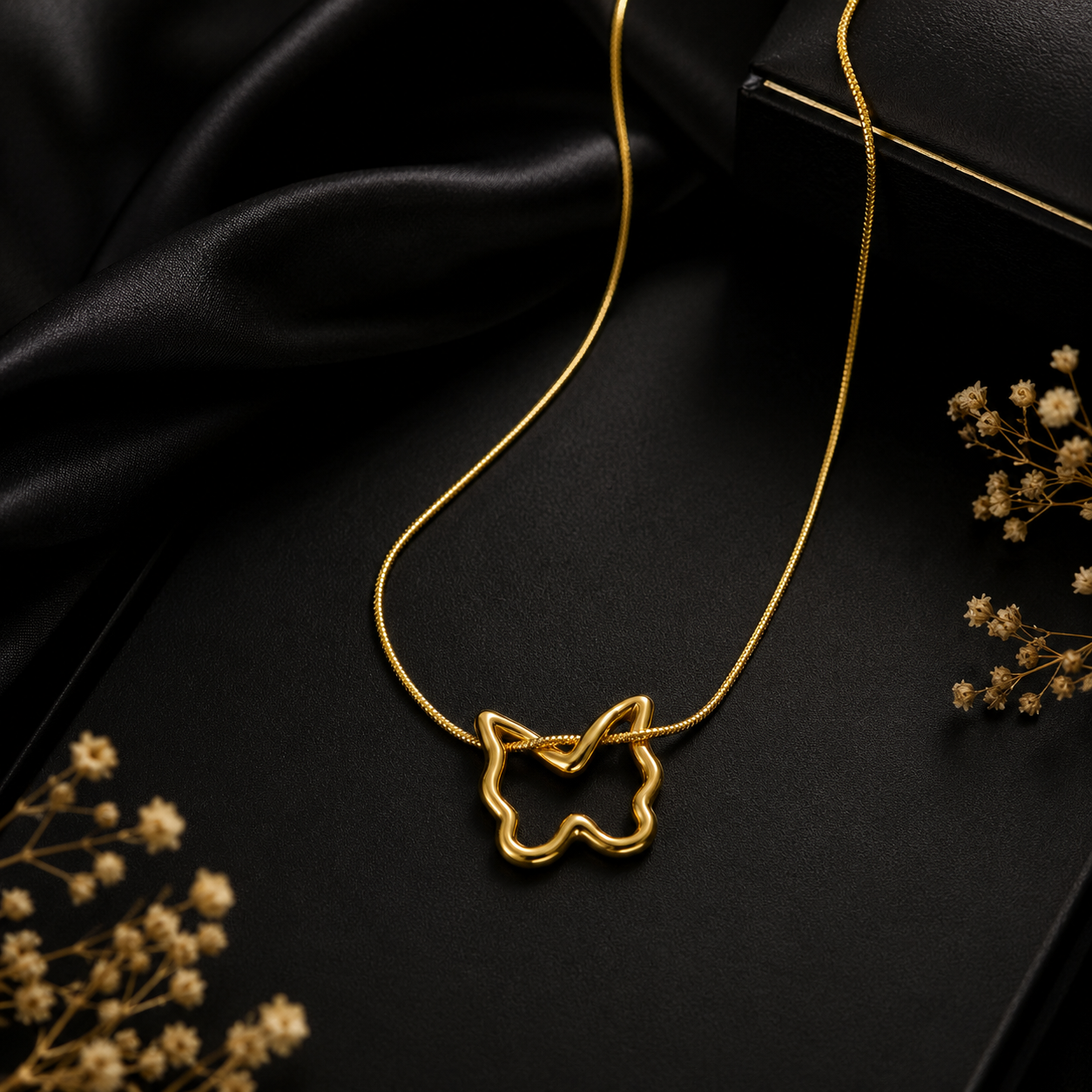 Close-up of gold butterfly outline charm pendant on slim box chain – gold-plated butterfly necklace bridesmaid jewelry