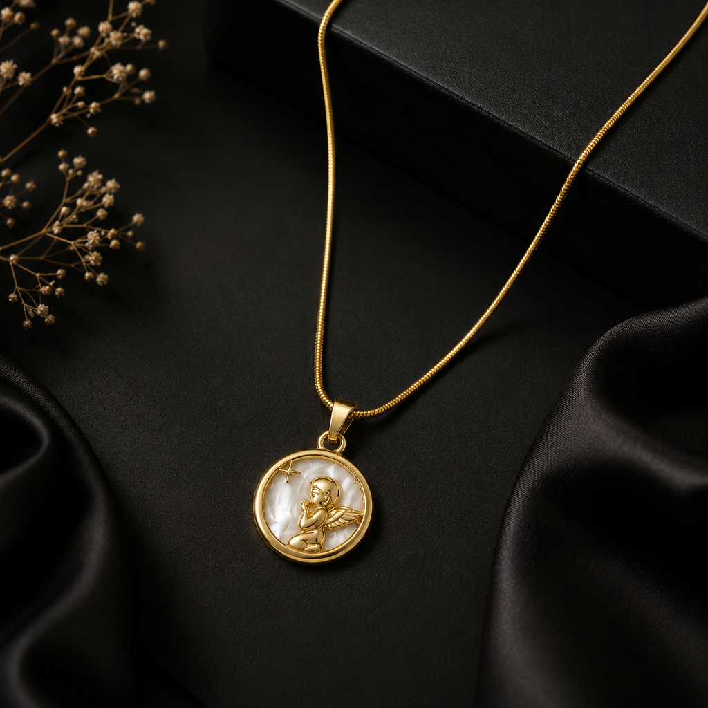Gold angel medallion pendant necklace on snake chain on teal and pink silk fabric with Aurelia Jewels branding card – luxury jewelry UAE Australia