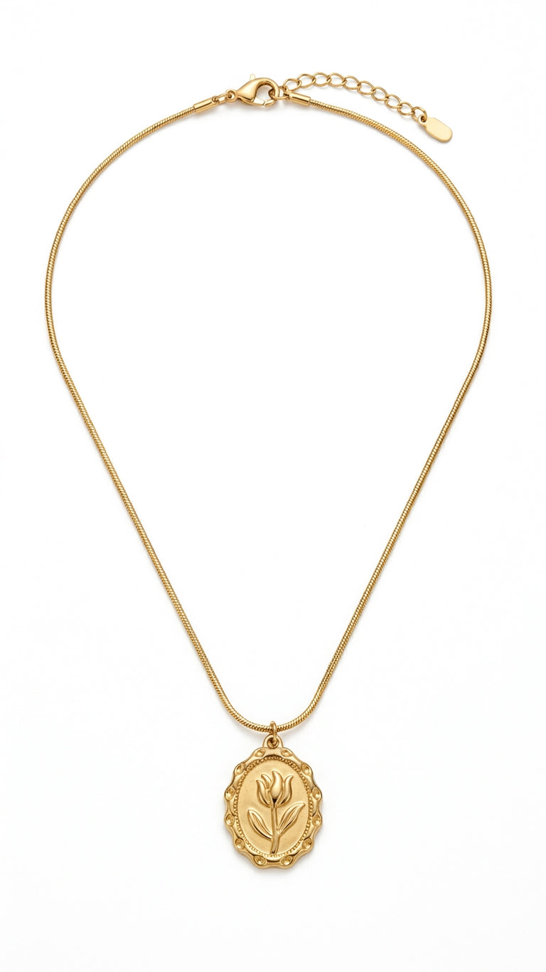 Gold oval tulip engraved medallion pendant necklace on flat snake chain flatlay on cream satin with lavender sprigs, dried rose and pearl ring dish – AureliaBlends gift for her