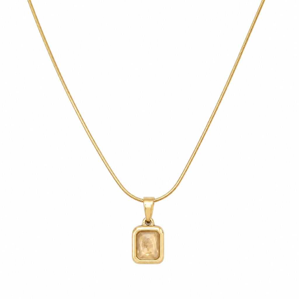 Gold bezel-set champagne crystal rectangle pendant necklace on snake chain flatlay on cream satin with dried baby's breath and gold ornate mirror – AureliaBlends gift for her
