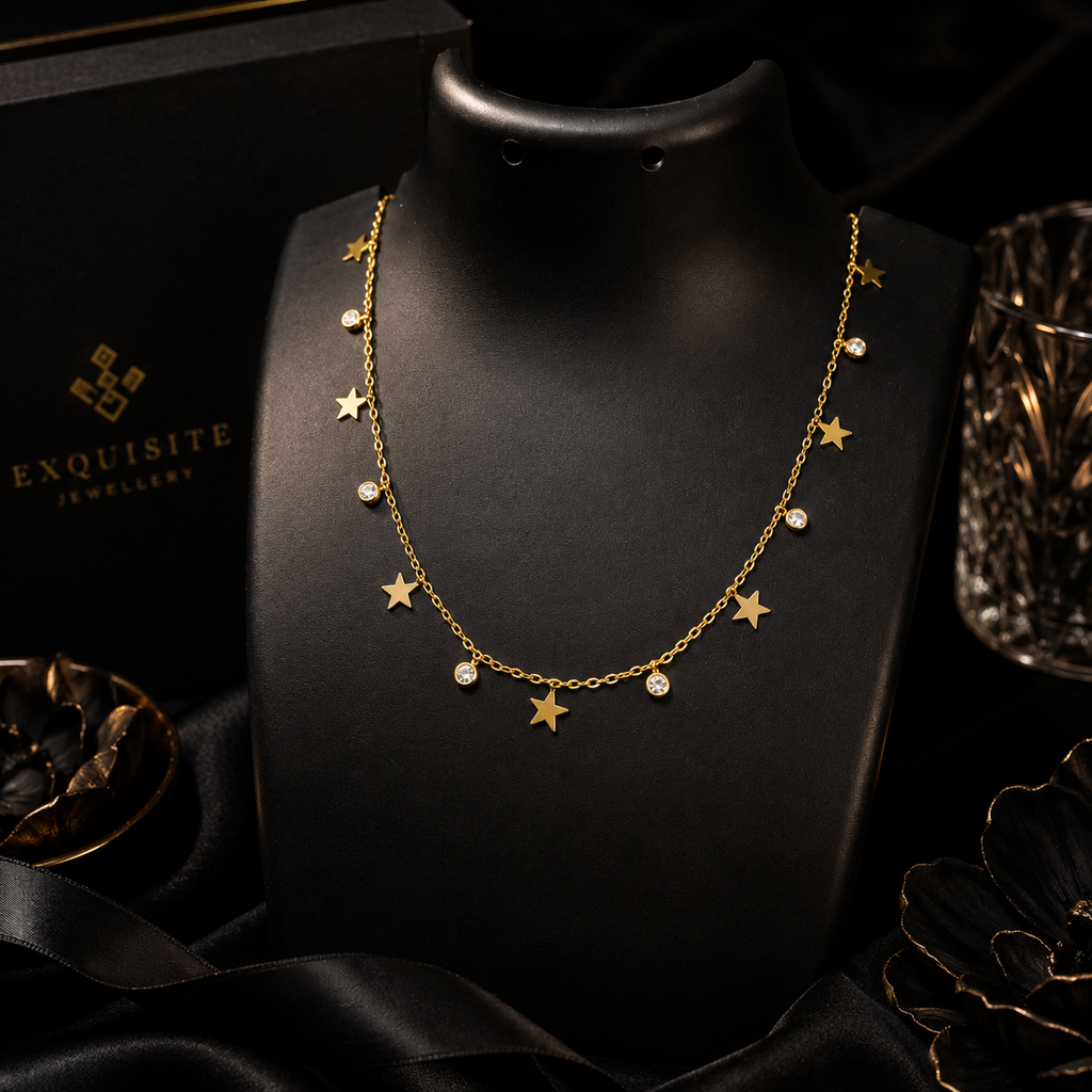 Gold star and CZ crystal dangle necklace flatlay on cream satin with baby's breath – dainty gold celestial charm necklace gift for her AureliaBlends