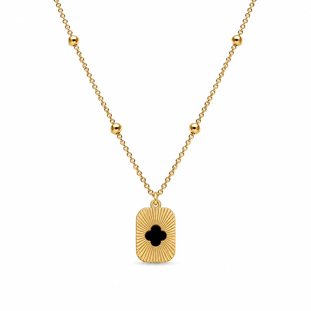 Gold sunburst clover cutout rectangle tag pendant necklace on satellite bead chain flatlay on cream satin with dried baby's breath and gold ornate mirror – AureliaBlends gift for her