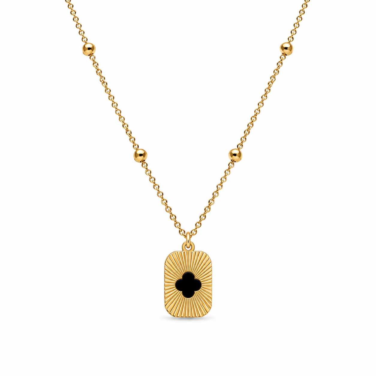 Gold sunburst clover cutout rectangle tag pendant necklace on satellite bead chain flatlay on cream satin with dried baby's breath and gold ornate mirror – AureliaBlends gift for her