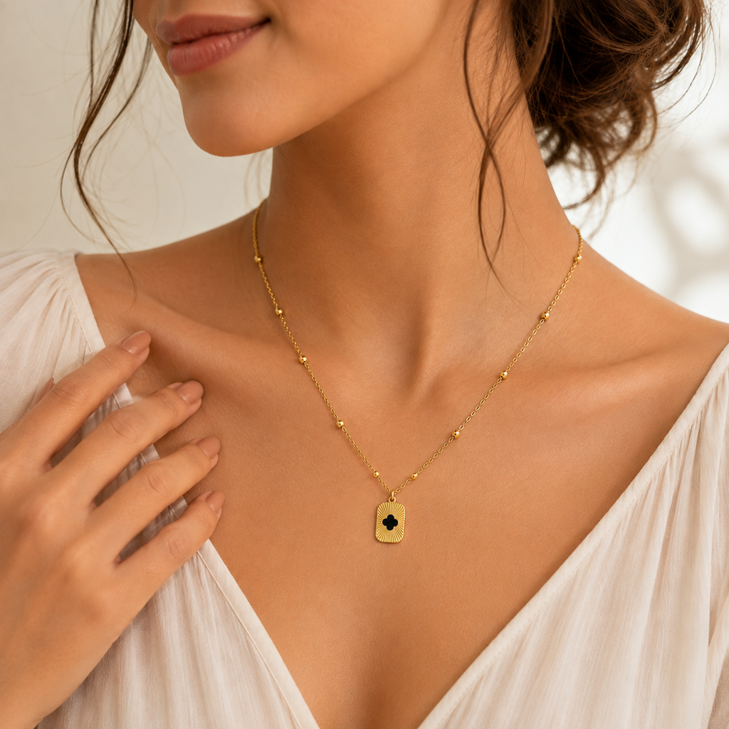 Gold clover cutout sunburst tag pendant necklace on satellite bead chain on black velvet with Timeless Beauty gift box and dried flowers – statement necklace AureliaBlends