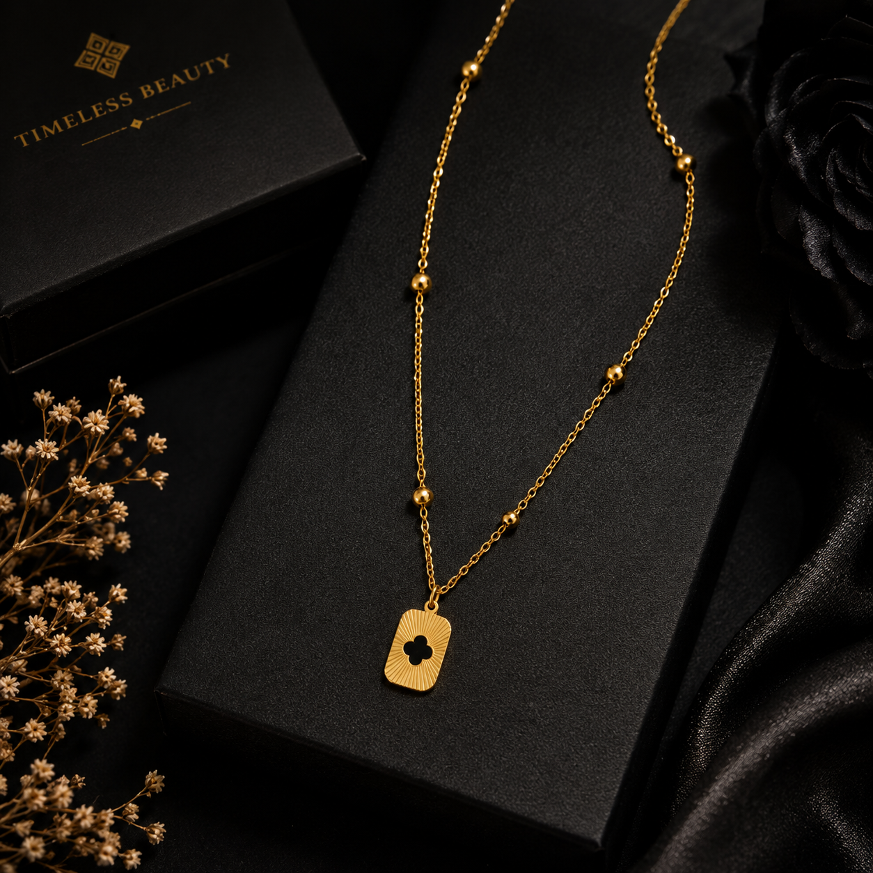 Gold sunburst clover tag pendant necklace on satellite chain with Timeless Beauty gift box on vibrant jewel-toned background with pink and teal florals – formal occasion jewelry UAE Australia