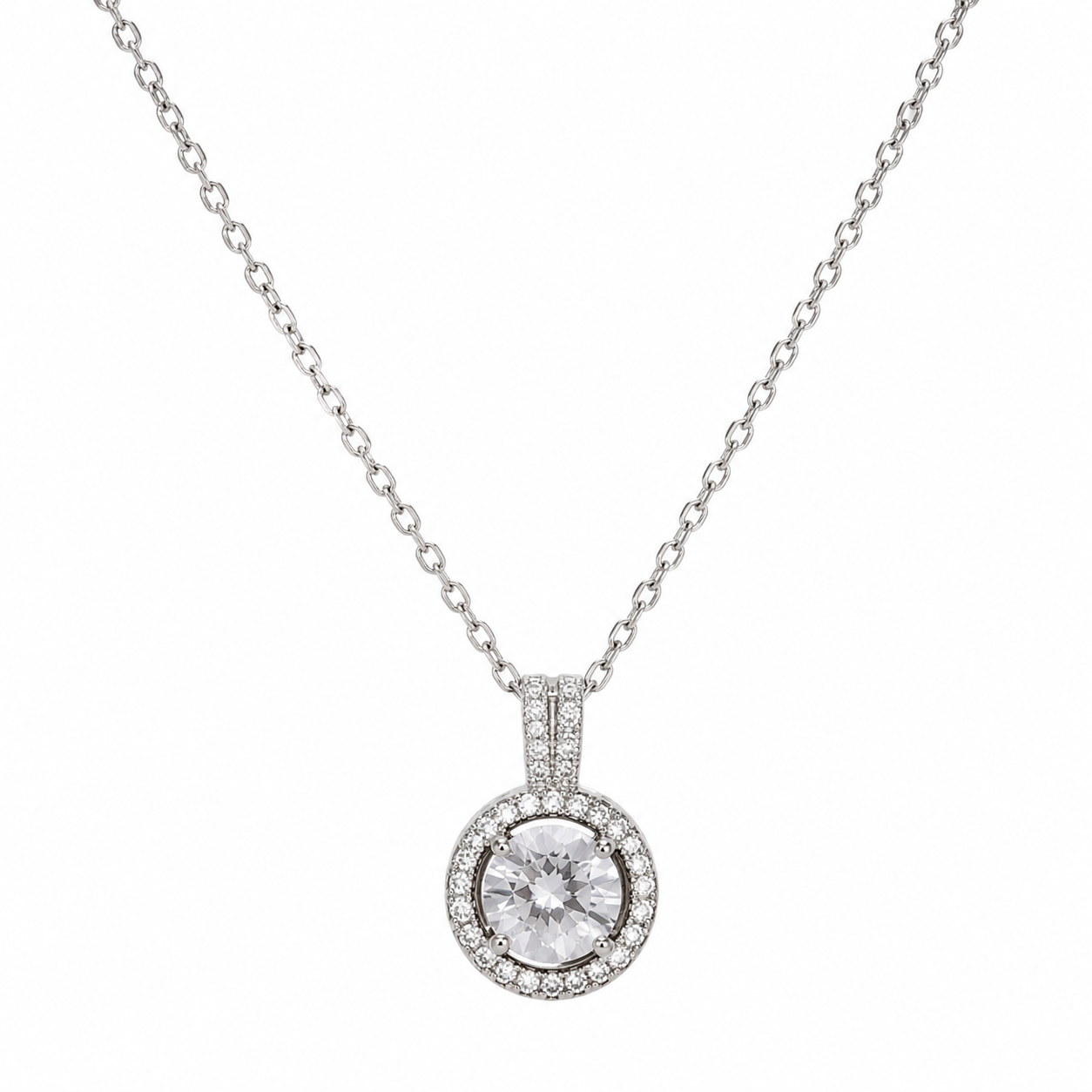 Silver round CZ halo pendant necklace with pavé surround and double-bar bail on fine cable chain flatlay on cream satin with crystal dish and dried baby's breath – diamond halo necklace AureliaBlends