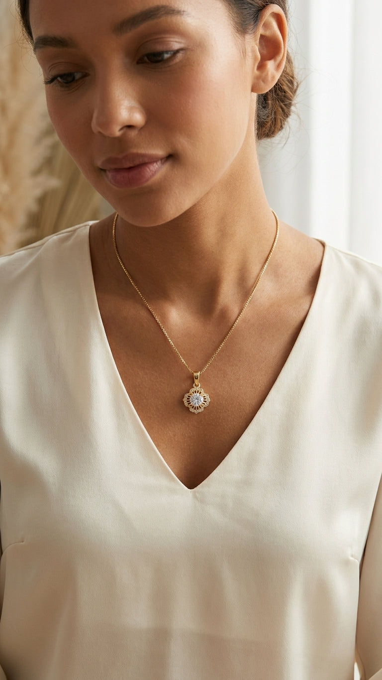 Gold vintage floral sunburst CZ pendant necklace in open beige velvet luxury gift box with satin bow on wooden table with white roses, baby's breath and 'Happy Birthday My Love' gift tag – birthday gift for her