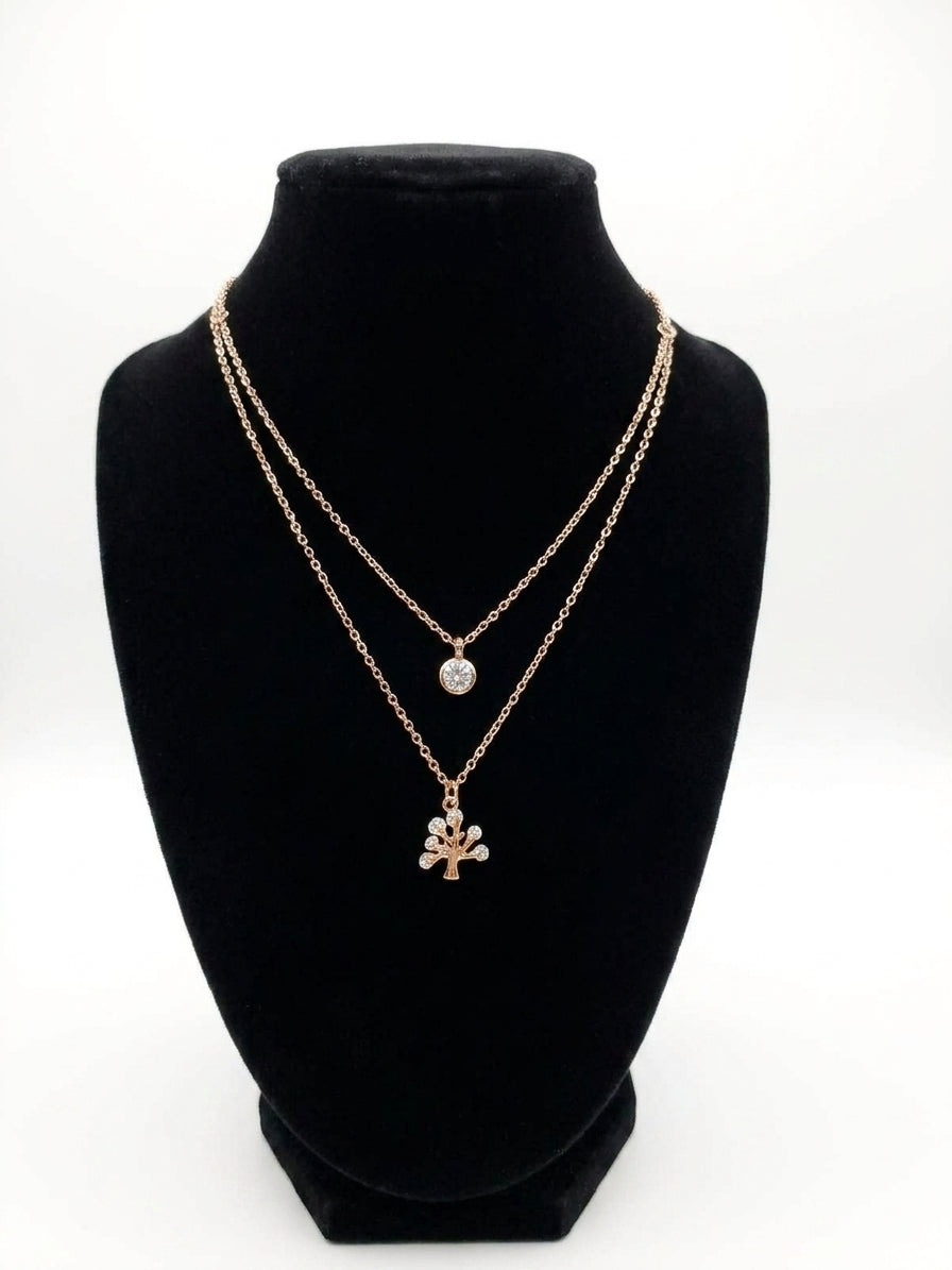 Rose gold double layer CZ solitaire and tree of life pendant necklace on black jewelry bust on white background – AureliaBlends