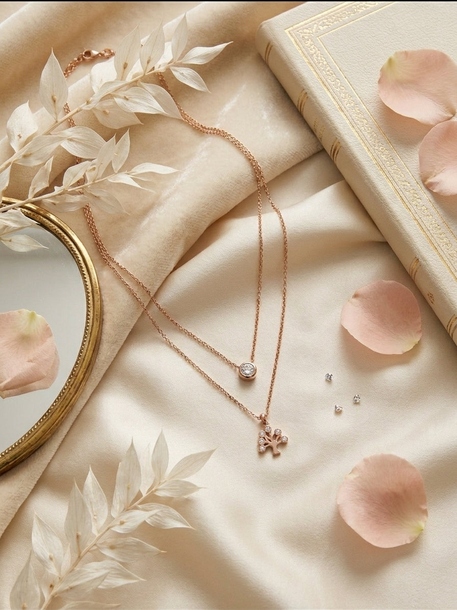 Woman wearing rose gold double layer CZ solitaire and tree of life pendant necklace on neck in cream V-neck top – AureliaBlends