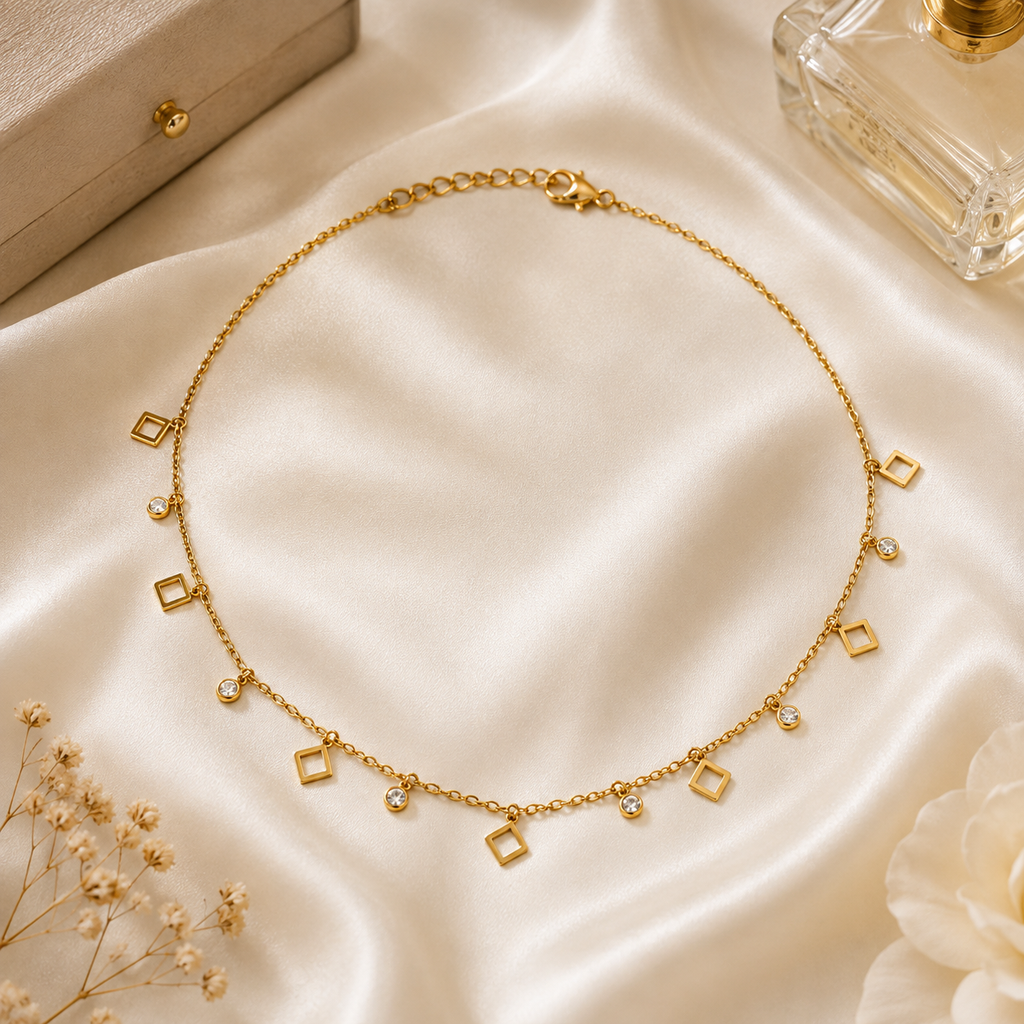 Gold open square and CZ bezel charm dangle necklace on black velvet jewelry bust surrounded by blush and cream garden roses and baby's breath – romantic bridal jewelry wedding guest necklace