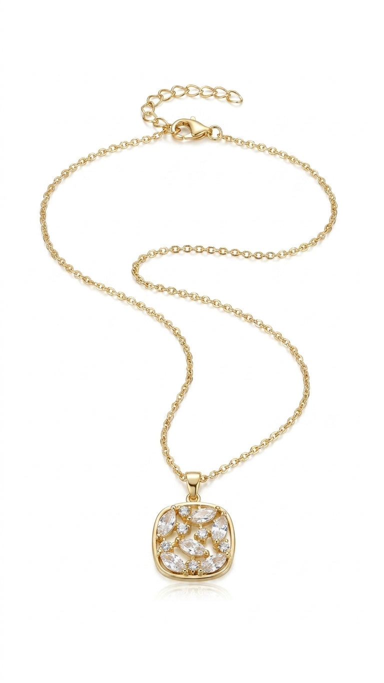 Gold-plated cushion CZ marquise pendant necklace displayed on jewelry bust surrounded by blush roses and white florals – bridal necklace by AureliaBlends