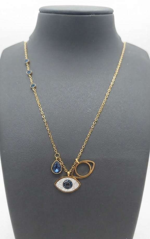 Gold-plated evil eye charm necklace with blue CZ teardrop and open circle pendants on grey jewelry bust – protection necklace by AureliaBlends