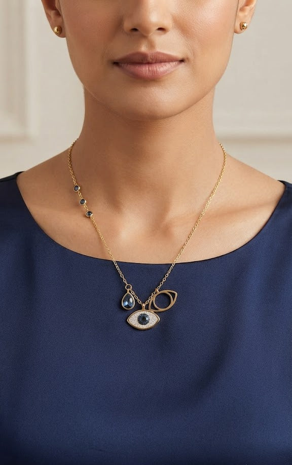 Evil eye gold charm necklace displayed on navy velvet bust inside luxury wooden jewelry box – gift for her by AureliaBlends