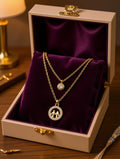 Gold-plated double layer family pendant necklace flat lay on brown silk with CZ solitaire and family circle charm – AureliaBlends