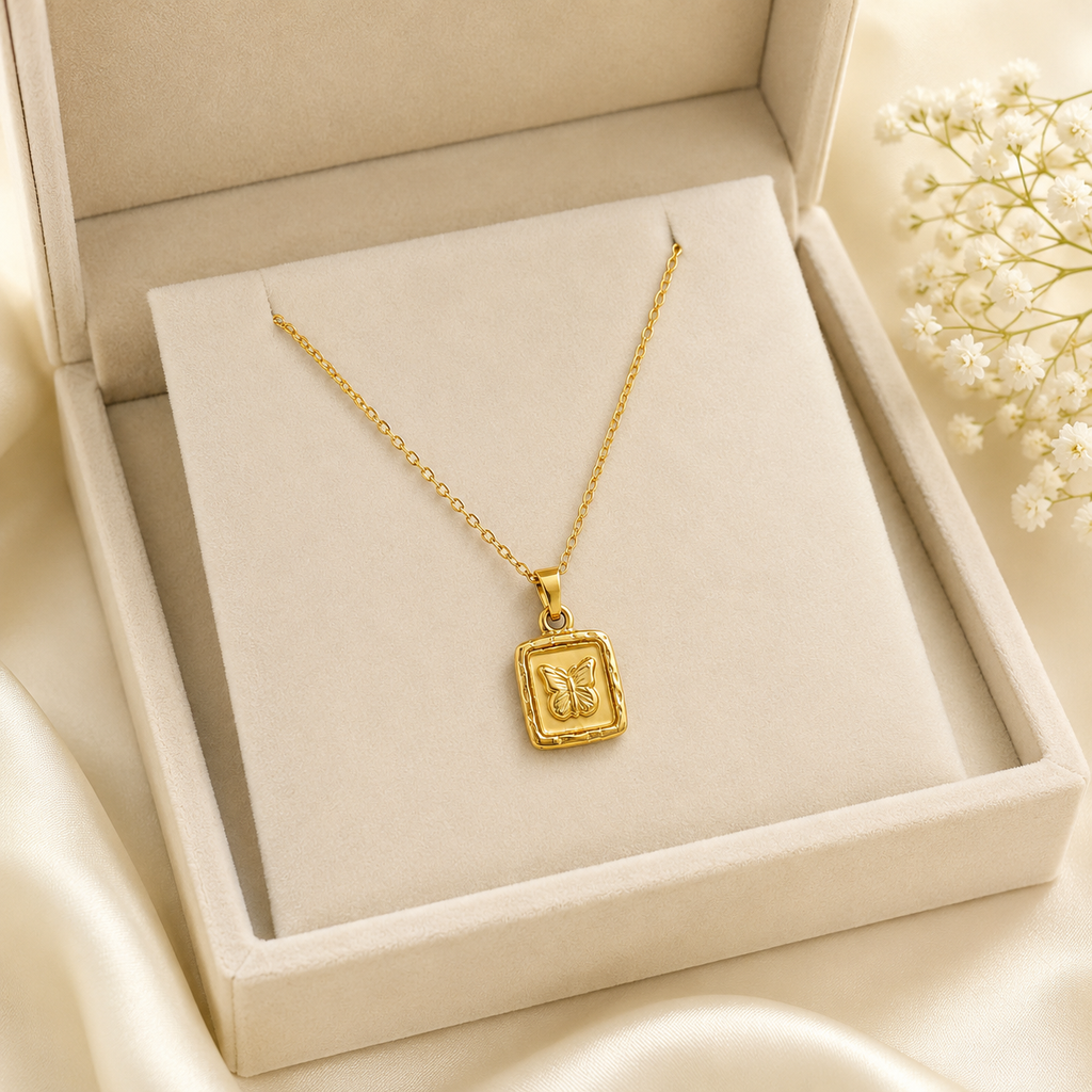 Gold butterfly medallion necklace worn on model in white top – dainty gold pendant necklace by AureliaBlends