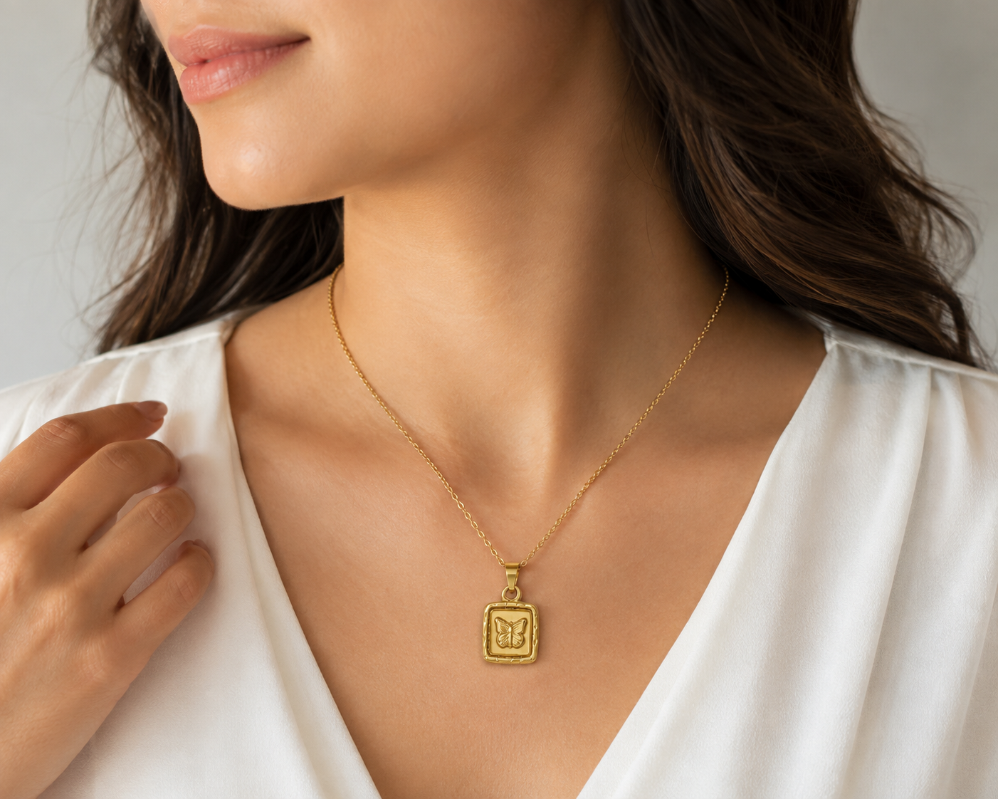 Gold butterfly square pendant necklace flat lay on cream satin with dried flowers – gift necklace for her AureliaBlends