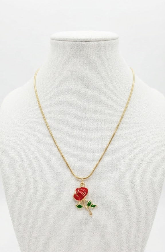 Gold red rose enamel charm necklace in burgundy velvet gift box on dark wood surface – romantic gold floral pendant necklace by AureliaBlends