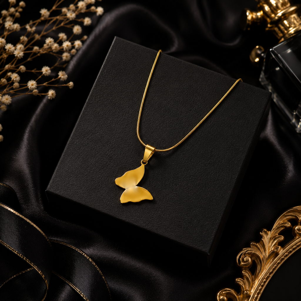 Gold butterfly pendant necklace on teal velvet hexagon display with colourful satin and flowers – statement gold necklace AureliaBlends