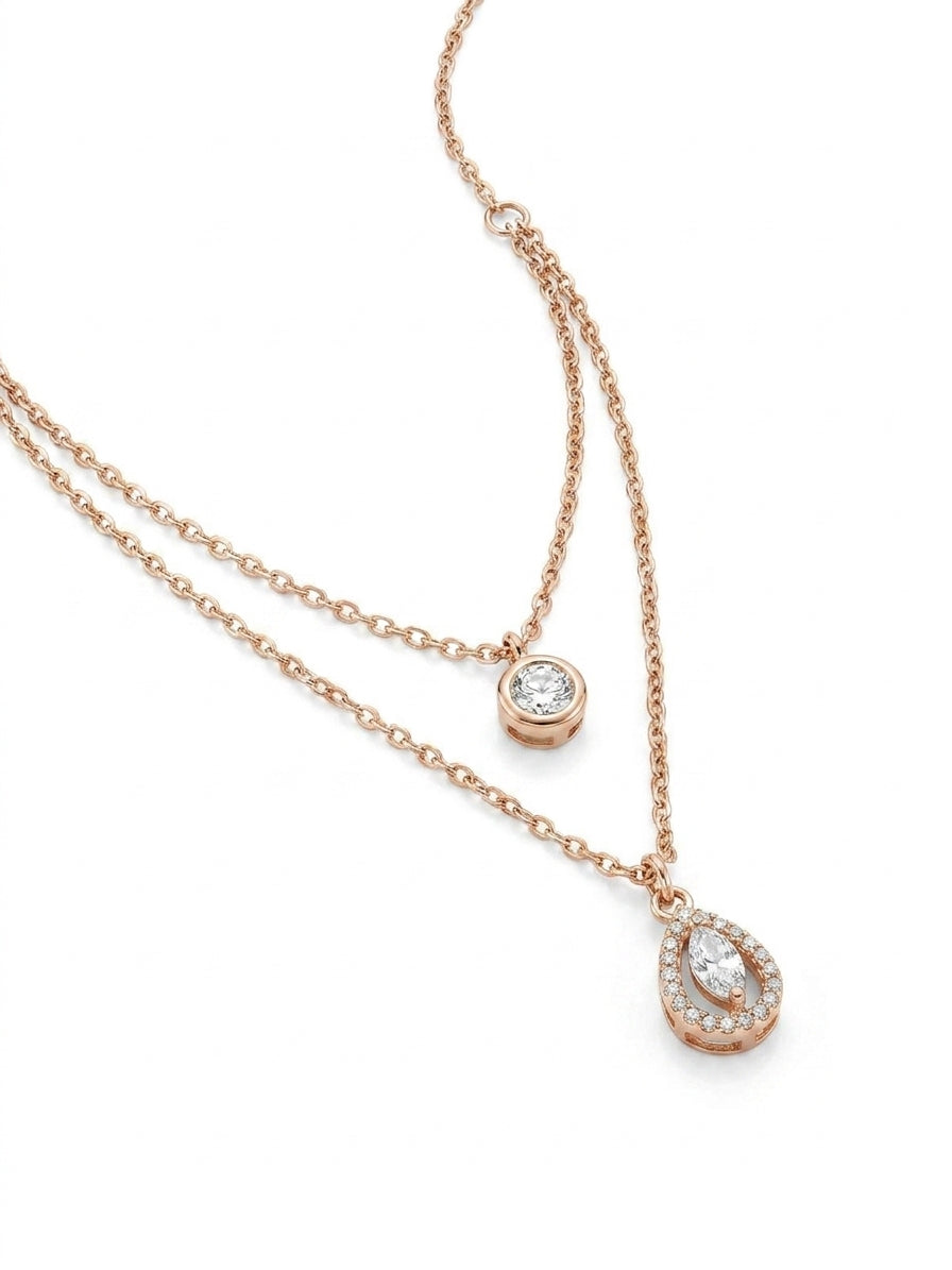 Rose gold double layer CZ solitaire and teardrop pendant necklace close-up on black velvet showing marquise halo pendant detail – AureliaBlends