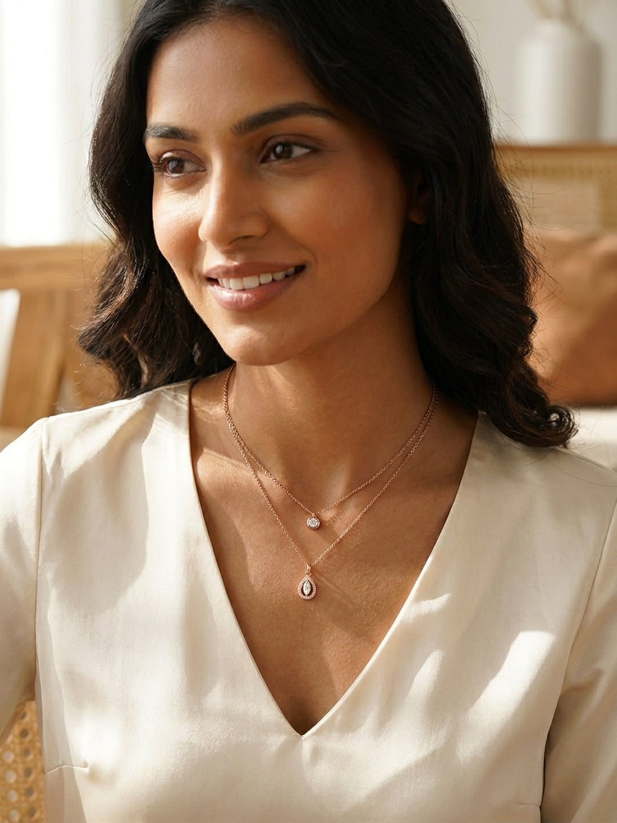 Rose gold double layer CZ solitaire and teardrop halo pendant necklace on blush velvet jewelry bust on cream silk – AureliaBlends
