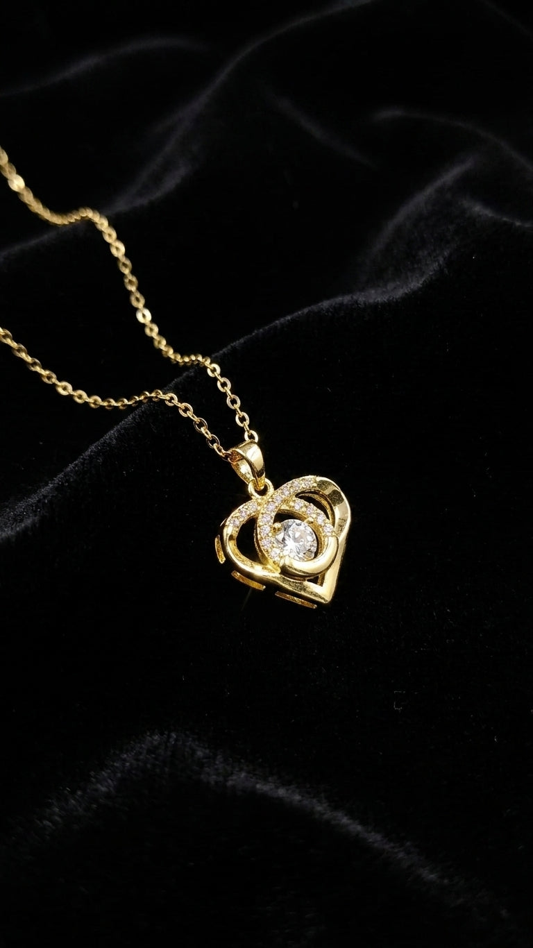 Gold CZ swirl heart pendant necklace on black velvet bust surrounded by blush roses and baby's breath – AureliaBlends romantic gift