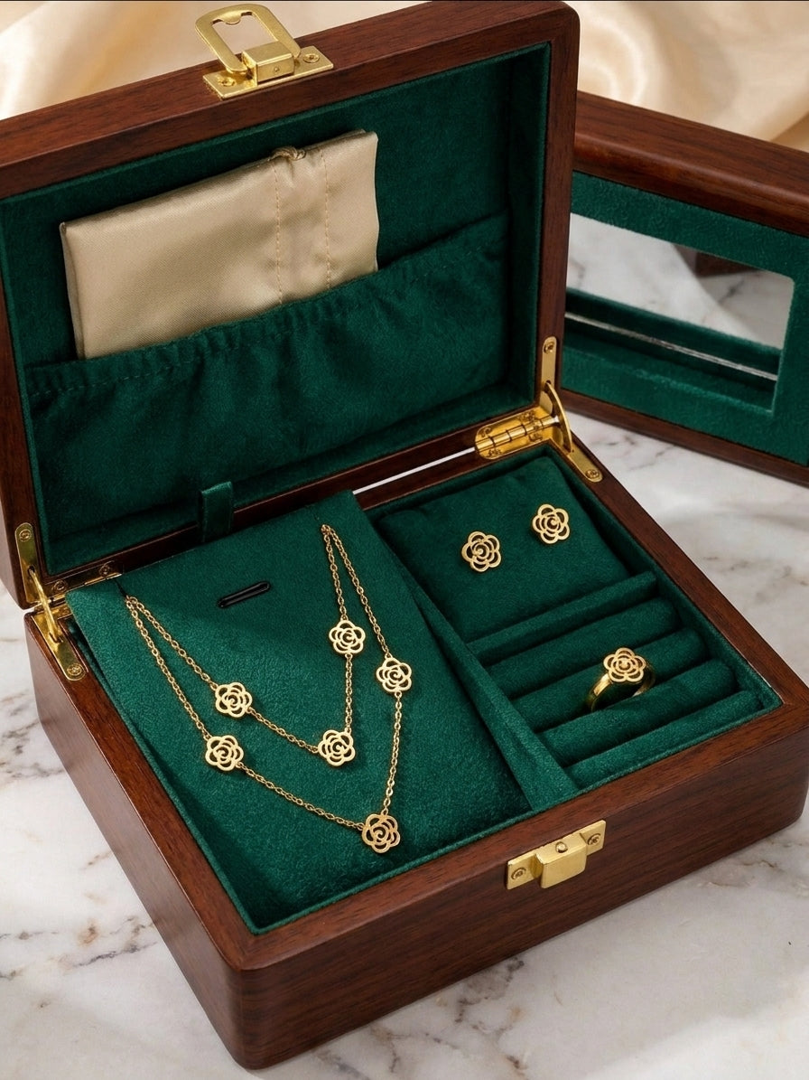 Gold filigree rose necklace, bracelet, earrings and ring set flat lay on black marble with black satin and glass jewellery box – luxury gold rose jewellery set AureliaBlends