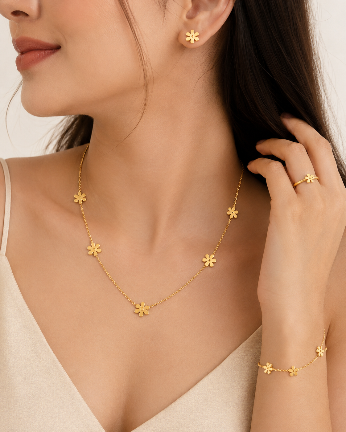 Gold daisy flower 4-piece jewellery set flat lay on black satin with dried flowers and gold lantern – luxury gold daisy set by AureliaBlends