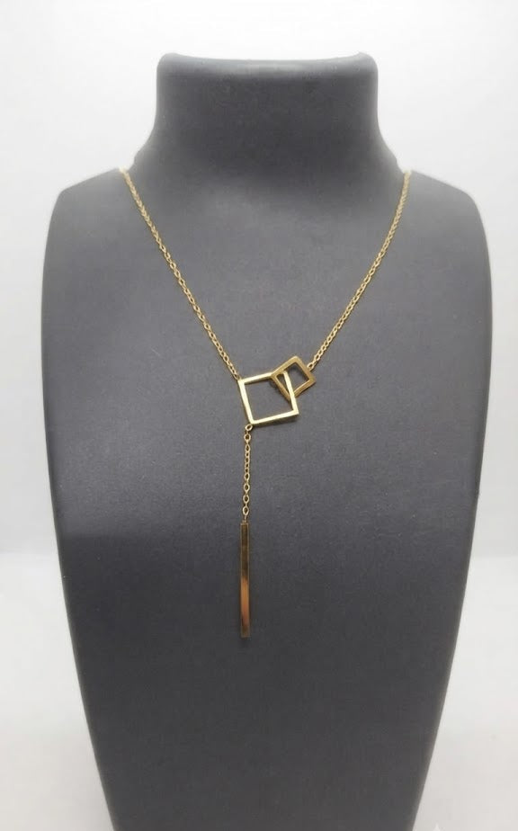 Gold geometric double square lariat Y-necklace with bar drop flat lay on white marble with silk scarf, navy velvet pouch and white ranunculus – minimalist 18K gold-plated lariat necklace by AureliaBlends