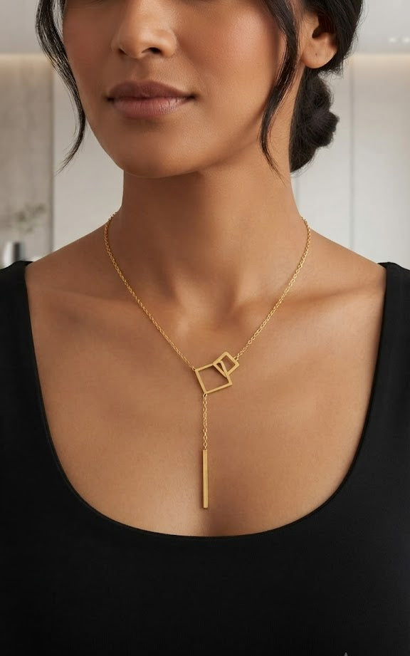 Gold geometric double square lariat Y-necklace with bar drop in open navy velvet gift box with With Love card, dried rose bud and burgundy satin ribbon on dark satin with rose petals and candle – romantic gift necklace AureliaBlends