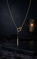 Close-up of gold double interlocking open square frames and bar drop pendant on delicate gold cable chain – 18K gold-plated geometric lariat Y-necklace detail by AureliaBlends