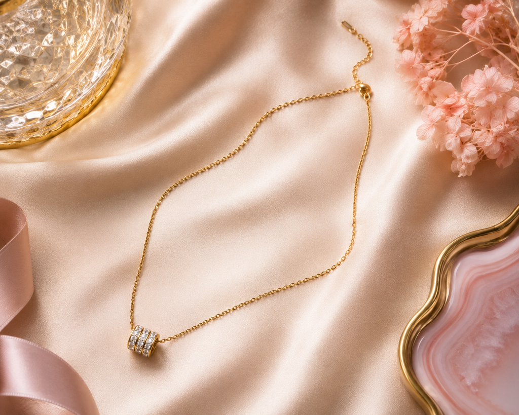 Gold triple pavé CZ crystal ring bead barrel pendant necklace flat lay on cream satin with gold botanicals and dried flowers – dainty sparkle gold necklace gift for her AureliaBlends