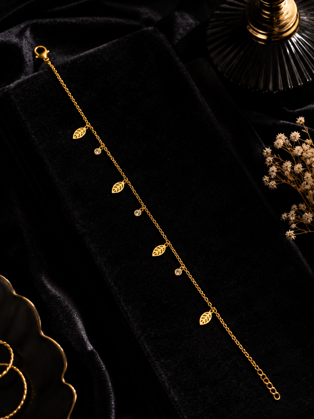 Gold-plated leaf charm bracelet displayed on beige velvet jewelry box with gold mirror frame – AureliaBlends