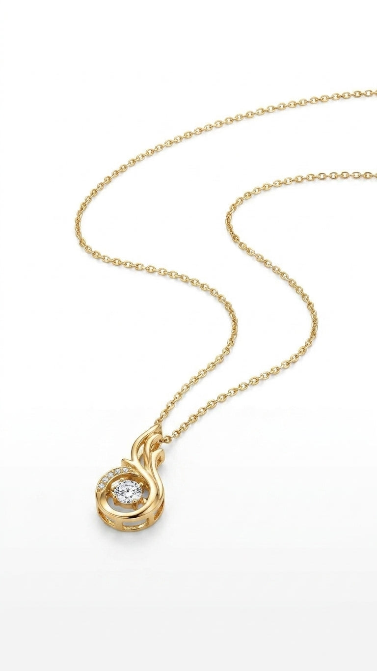 Woman wearing gold CZ flame swirl pendant necklace with cream silk V-neck blouse in warm sunlit interior – AureliaBlends Lumière Collection lifestyle shot