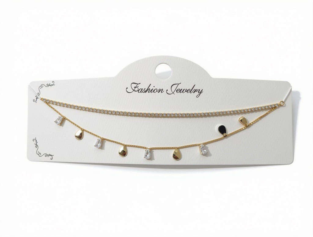 A gold-tone double-strand fashion jewelry necklace with small dangling charms, displayed on a white card labeled 'Fashion Jewelry' against a white background.
