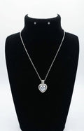 Silver CZ heart halo pendant necklace flat lay on black leather with gold fountain pen, lavender and Timeless Elegance card – AureliaBlends