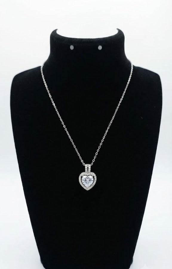 Silver CZ heart halo pendant necklace flat lay on black leather with gold fountain pen, lavender and Timeless Elegance card – AureliaBlends