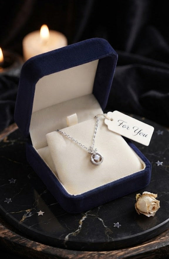 Silver CZ halo circle pendant necklace displayed on grey velvet jewelry bust in luxury Aurora Fine Jewels boutique showcase