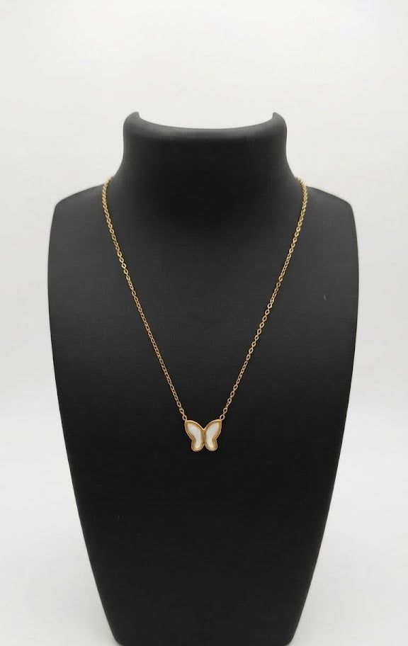 Woman wearing dainty gold butterfly mother of pearl necklace with black silk top – AureliaBlends butterfly pendant necklace