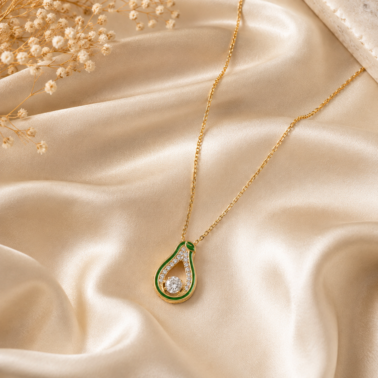 Gold green enamel teardrop CZ pendant necklace on black satin fabric with dried flowers – AureliaBlends statement necklace product shot